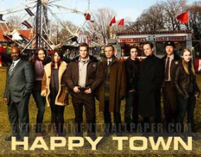 A group of friends standing together outdoors at an amusement park with rides and flags in the background, sunny day, casual and semi-formal clothing, with the text 'HAPPY TOWN' at the bottom.