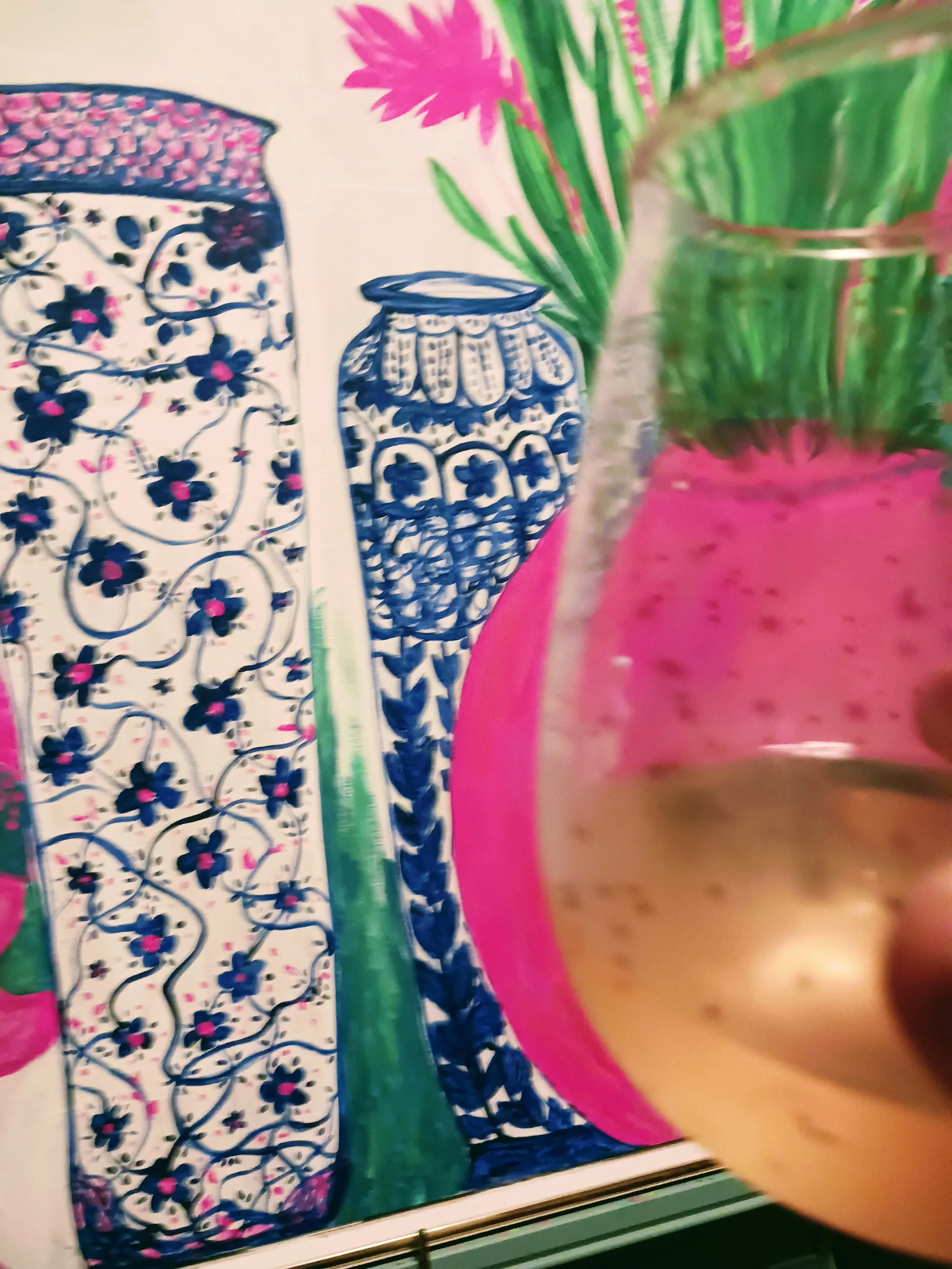 Colorful painting of three ornate vases with floral and geometric patterns, with a pink vase in the foreground and a green-topped plant behind it.