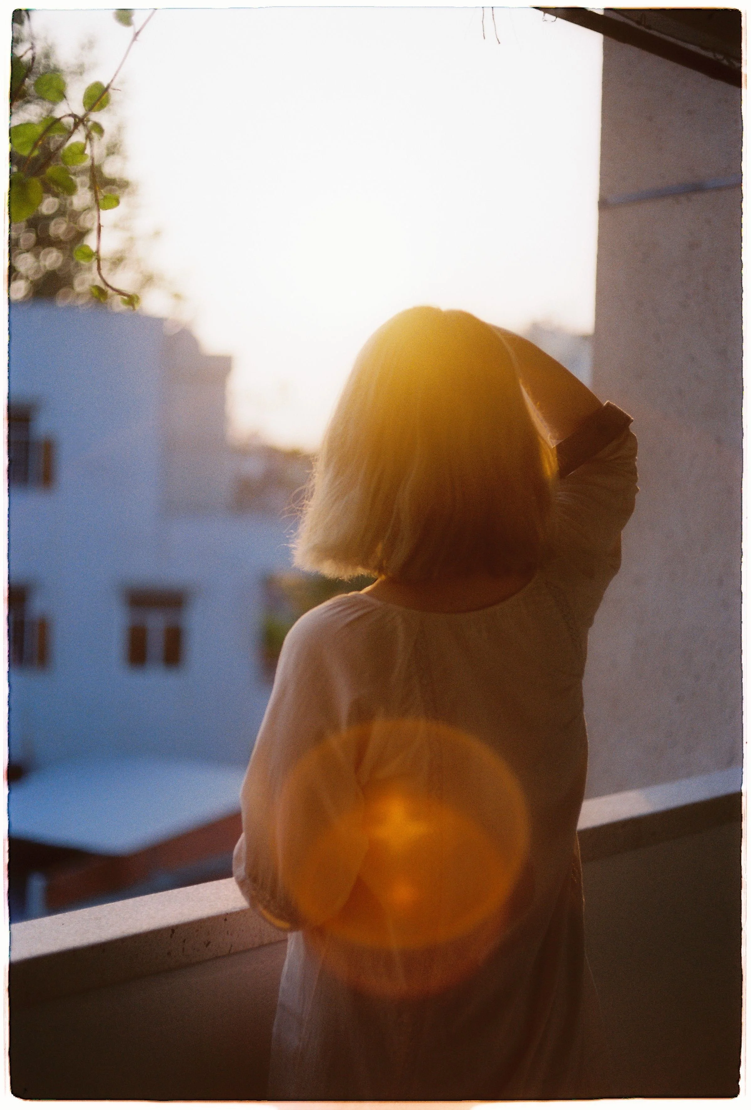 Woman gazing out window in soft natural light, representing the quiet exhaustion of late-diagnosed ADHD in women