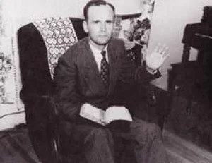 Brother Branham Sitting and Holding the Bible