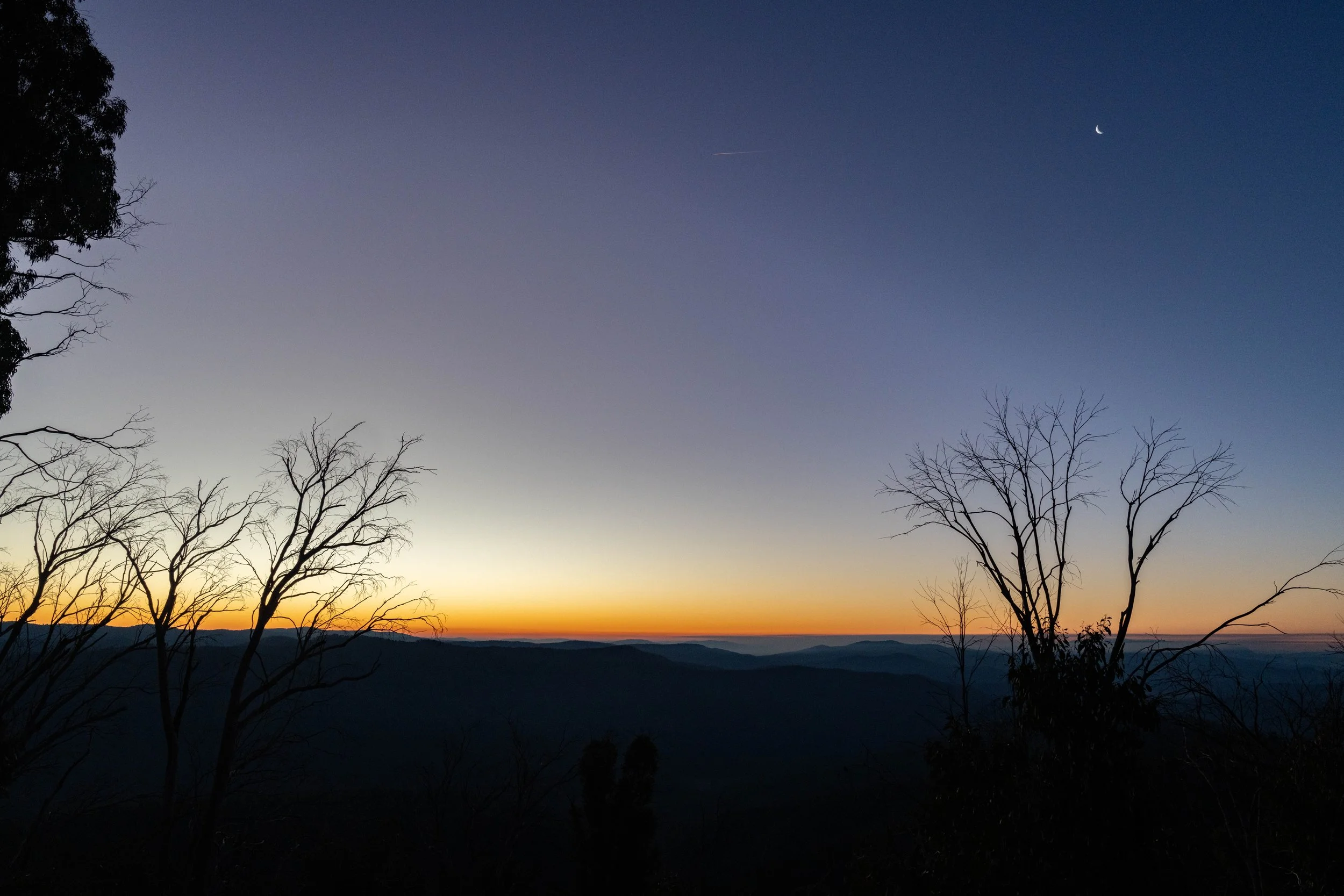 A late evening sunset is pictured with stars beginning to peek through and the colours ranging from orange to purple. Captured by photographer Ian Grant. 