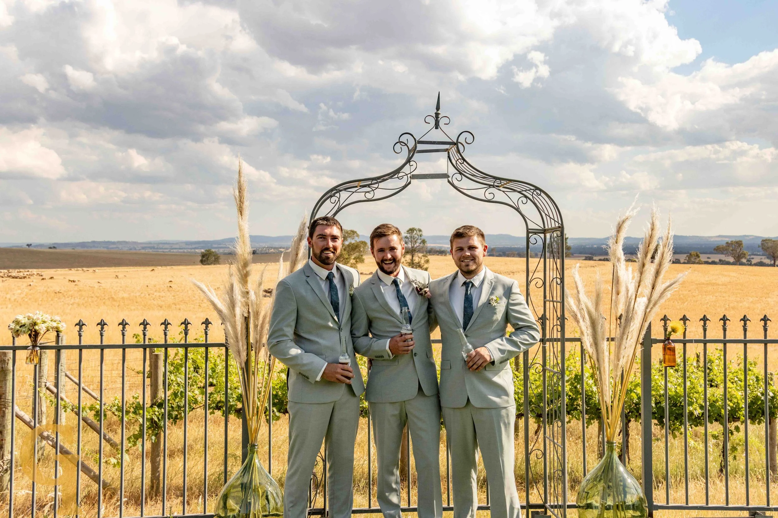 Three guys standing in front of the alter smiling and having a fun time.