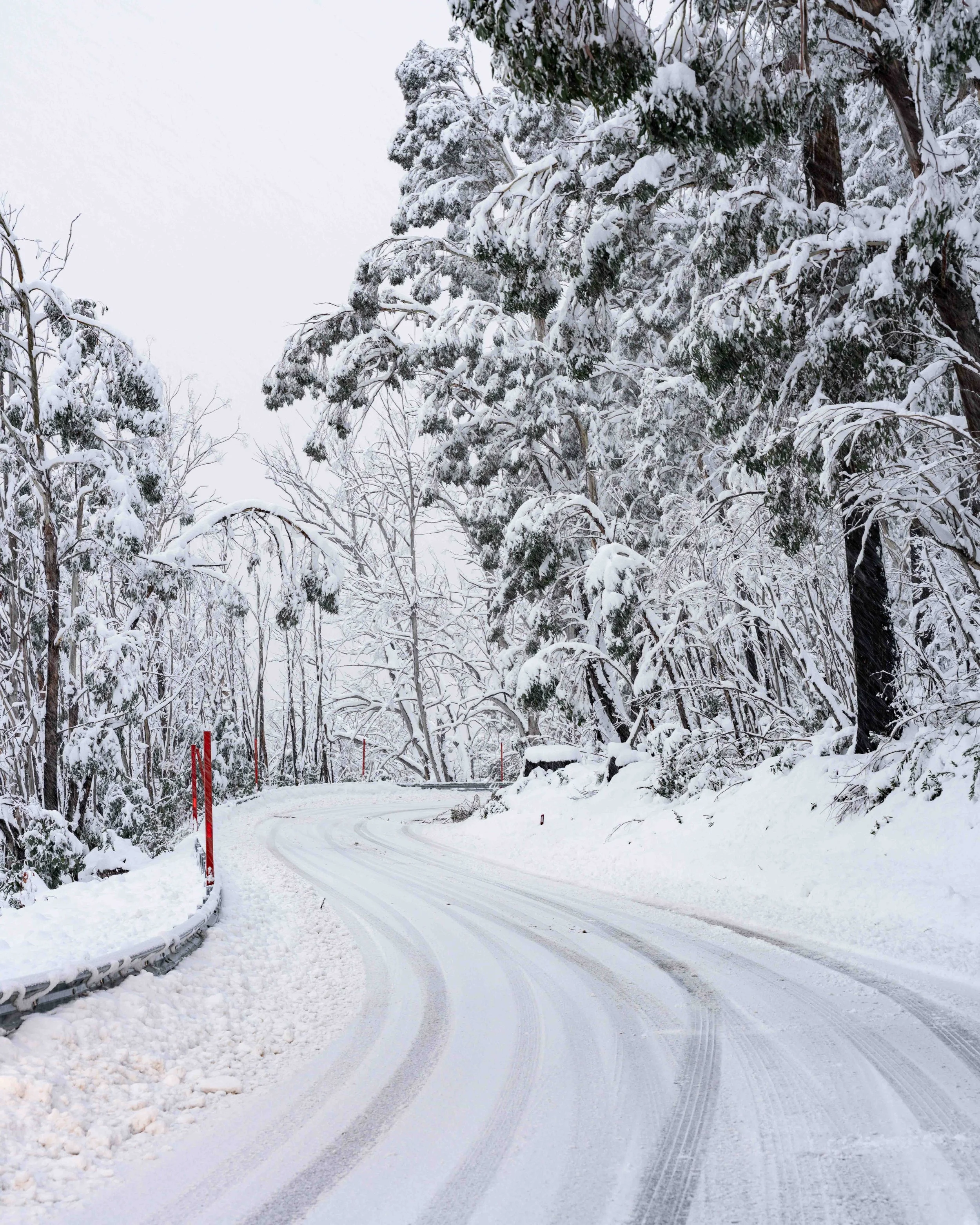 A windy road covered in snow is pictured. Taken in the Snowy Mountains, NSW, captured by photographer Ian Grant. 