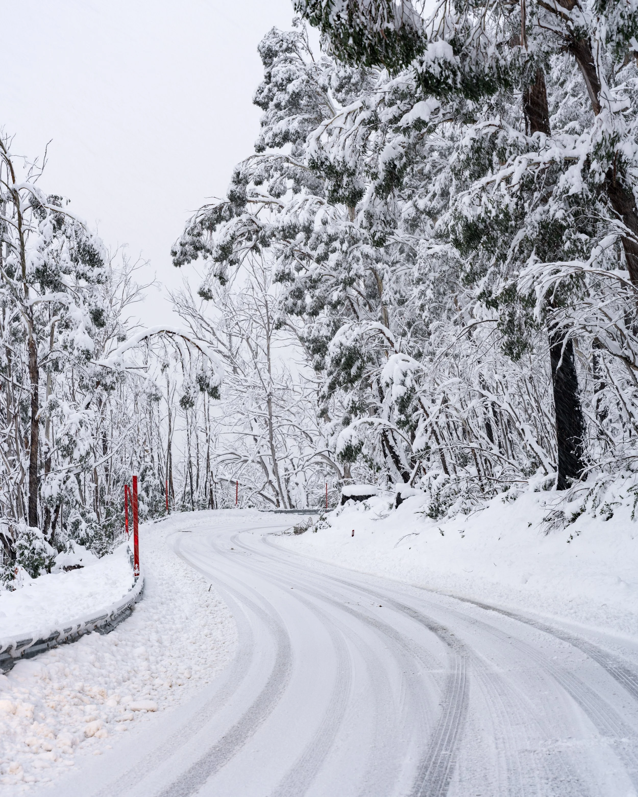 A windy road covered in snow is pictured. Taken in the Snowy Mountains, NSW, captured by photographer Ian Grant. 