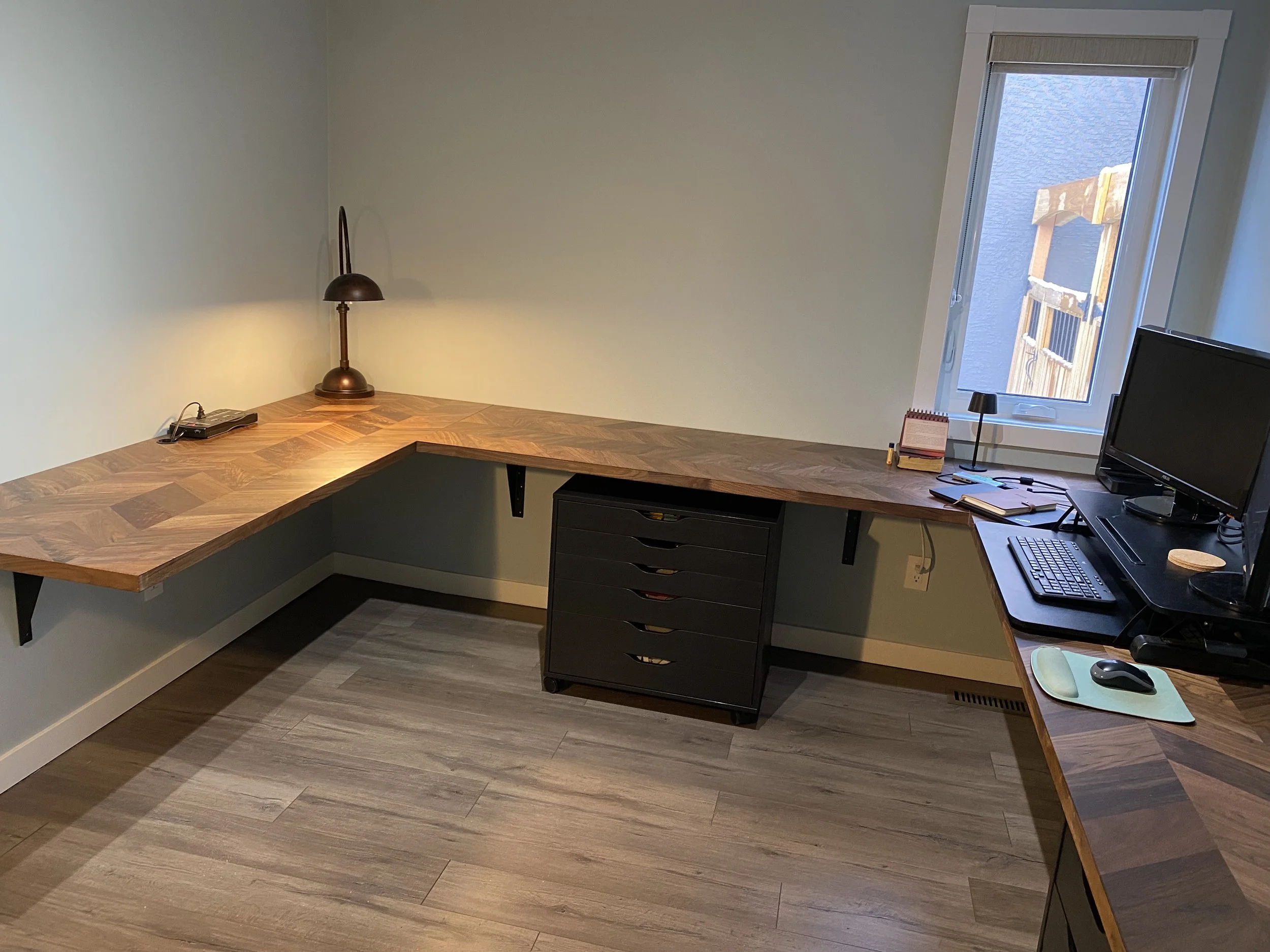 After pic of home office with custom floating desk at correct height for client and added storage.