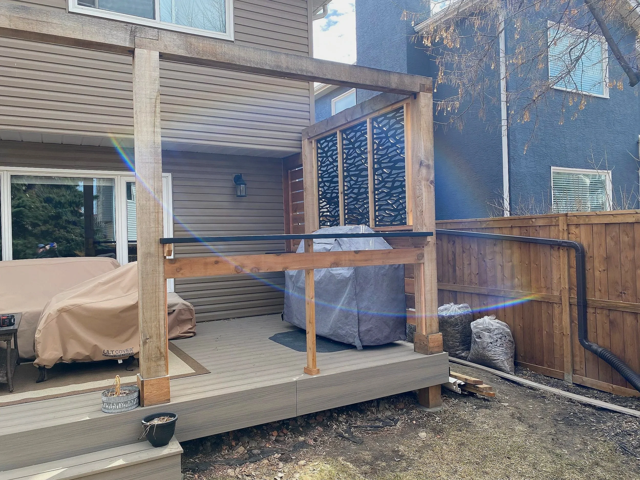 Built cedar and composite privacy screen and built-in counter tops for privacy, security and easy access to back door.