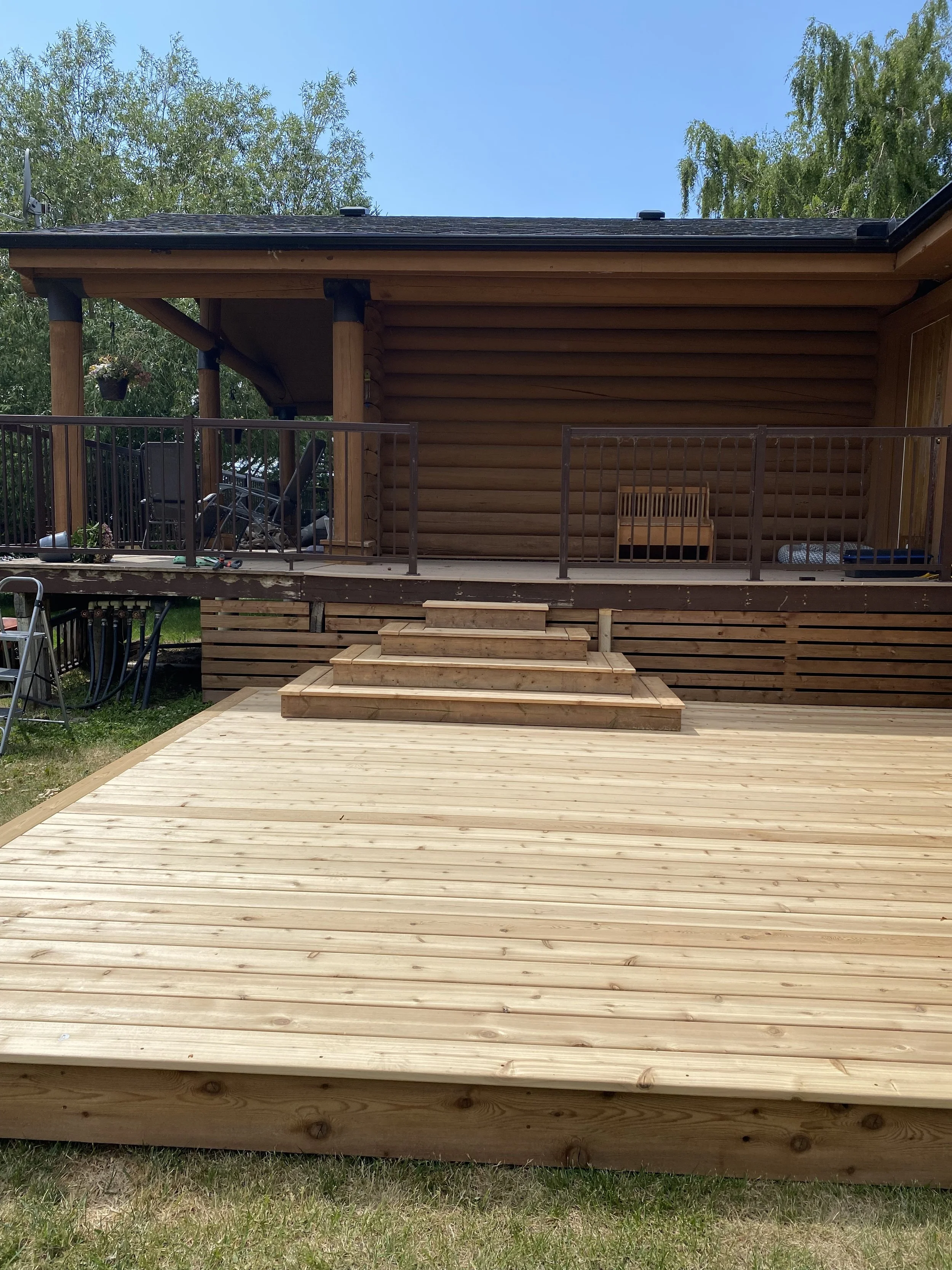 Built new cedar, ground-level deck, box stairs  and skirting for safe and comfortable entry to home.