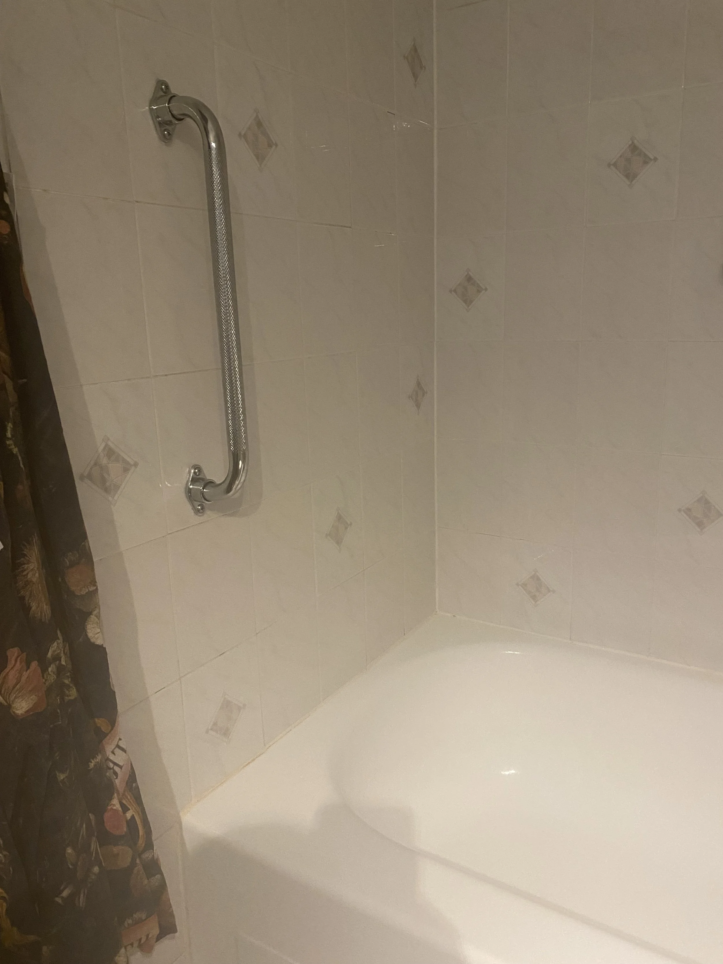 Installed vertical and horizontal grab bars in primary bathroom (tile) for client with mobility challenges.