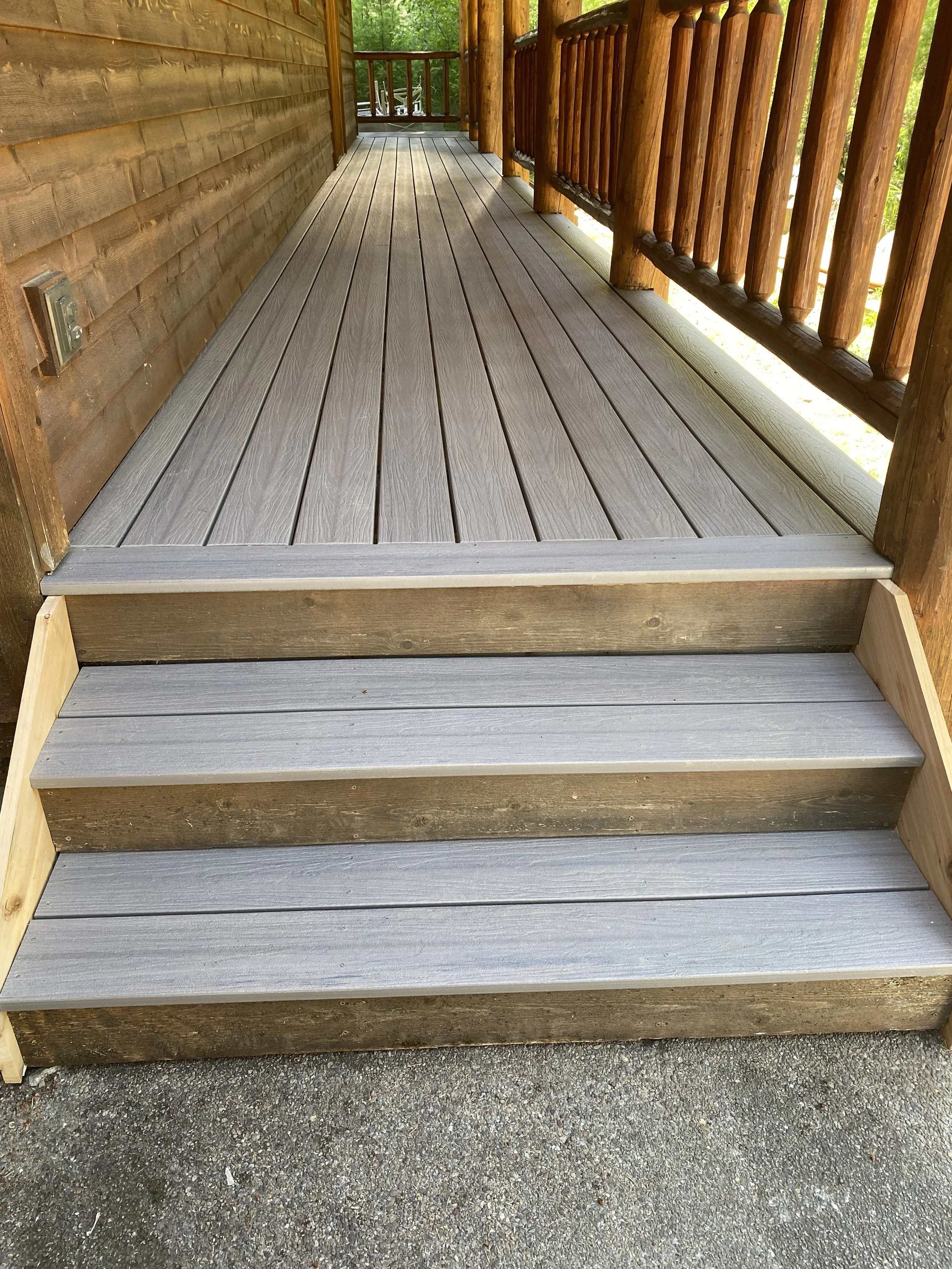 Rebuilt front steps with composite decking and cedar fascia for safe and comfortable access to front entrance to home.
