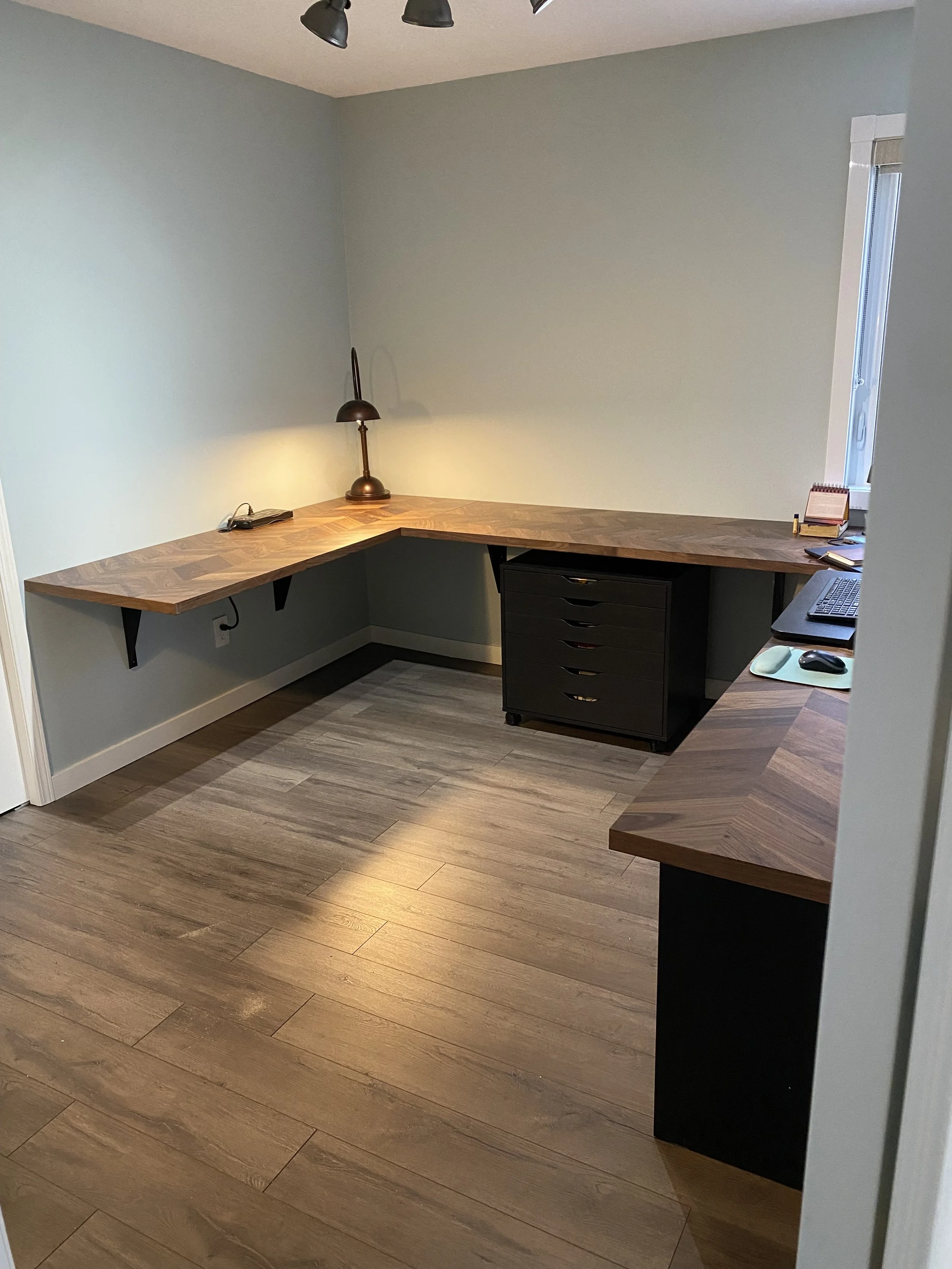 After pic of home office with custom floating desk at correct height for client and added storage.