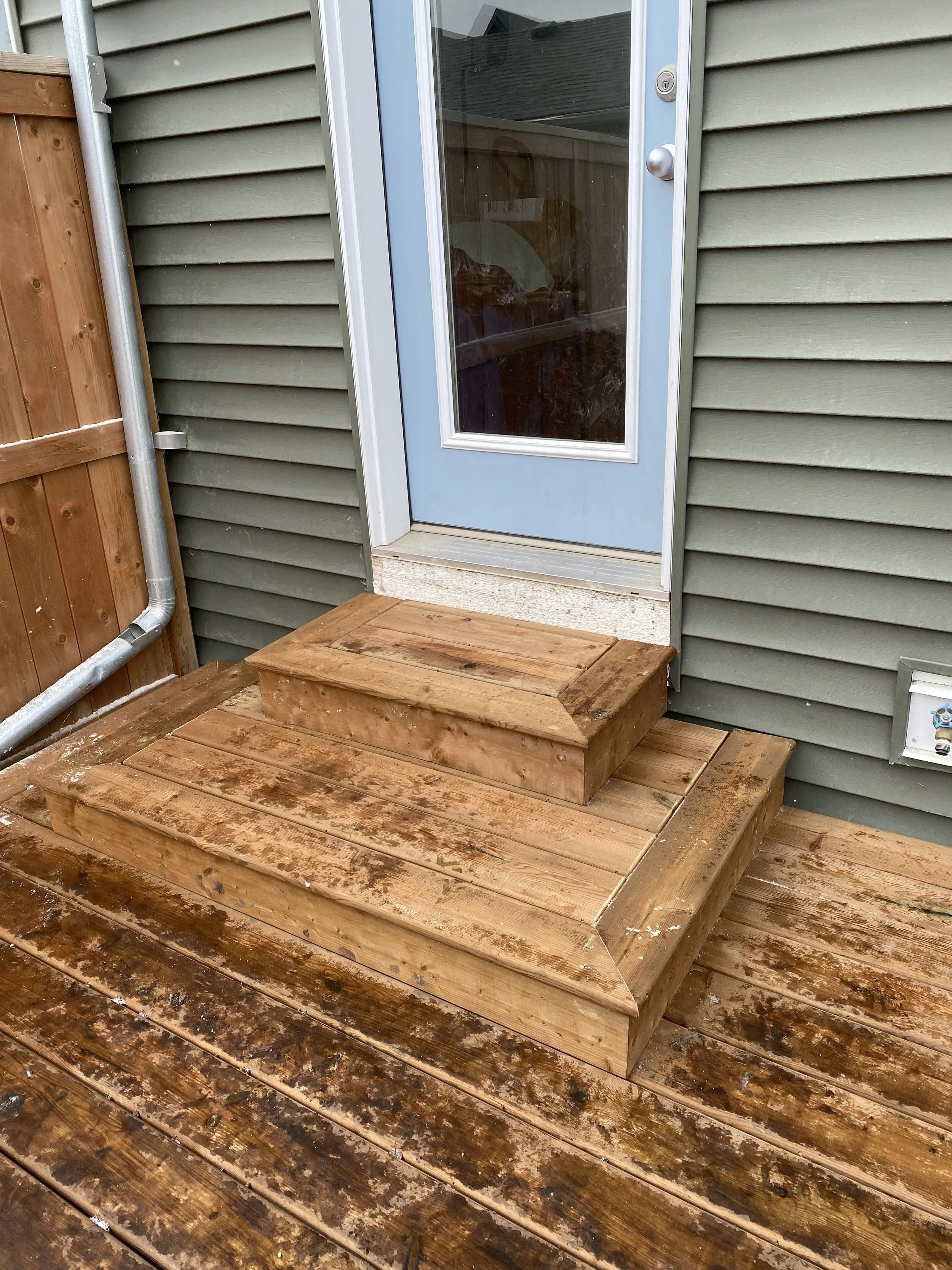 Built small, ground-level deck and box stairs for safe and comfortable back door home access.