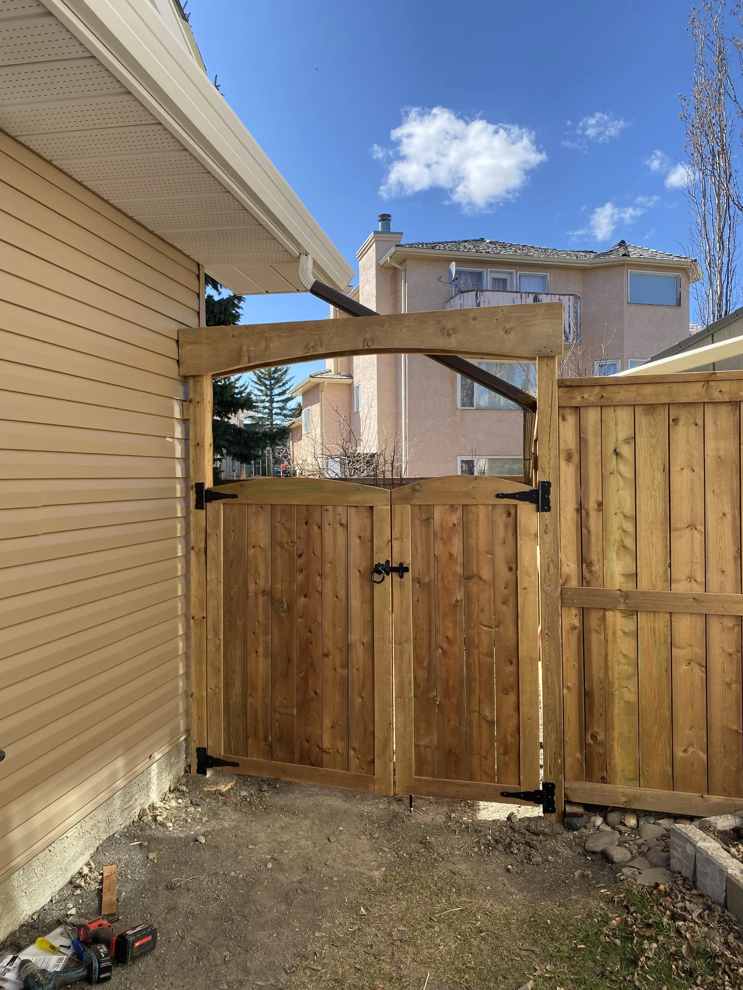 Built custom double gate with strong bracing, allowing access for large equipment and backyard security.