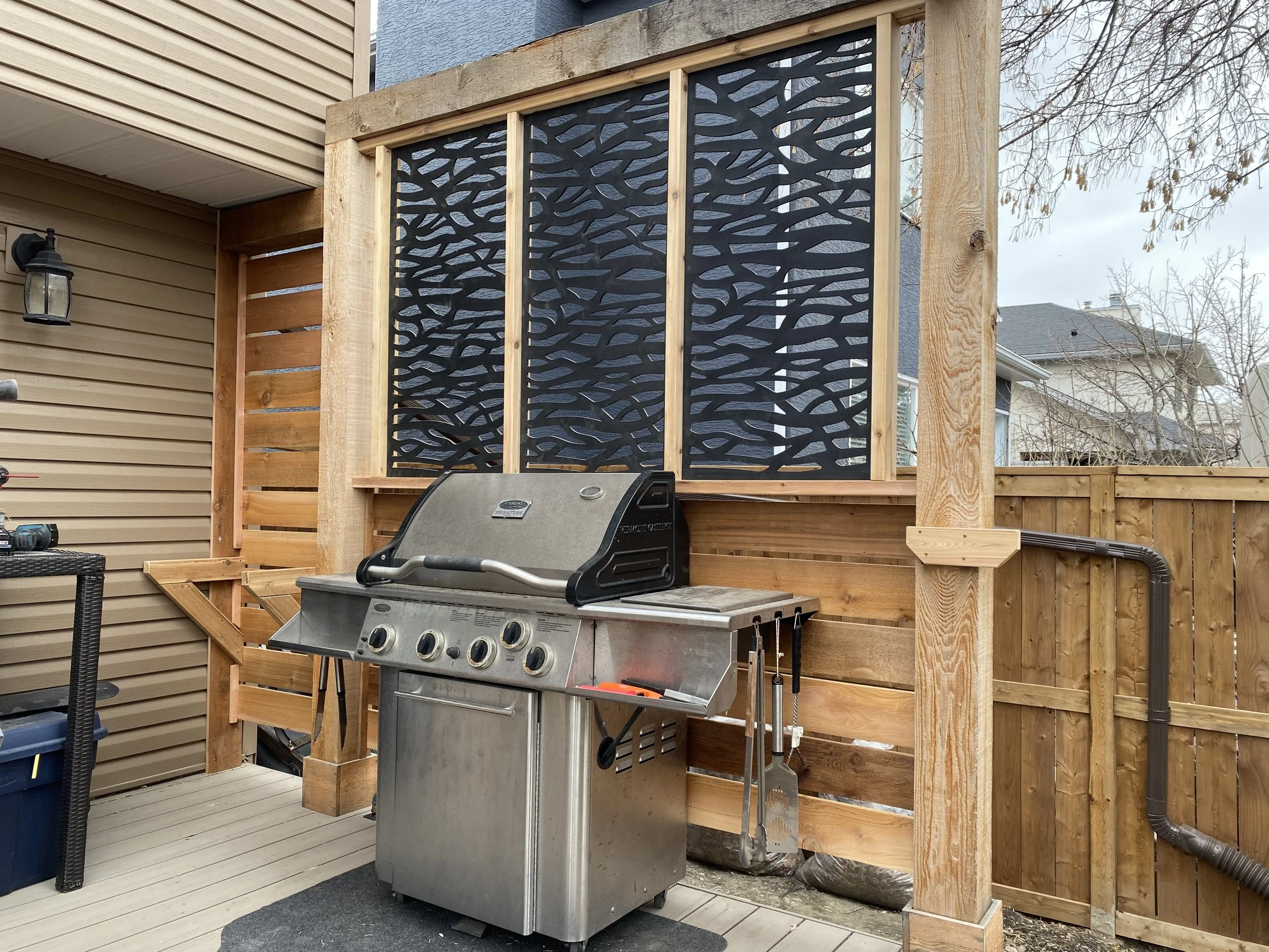 Built cedar and composite privacy screen and built-in counter tops for privacy, security and easy access to back door.