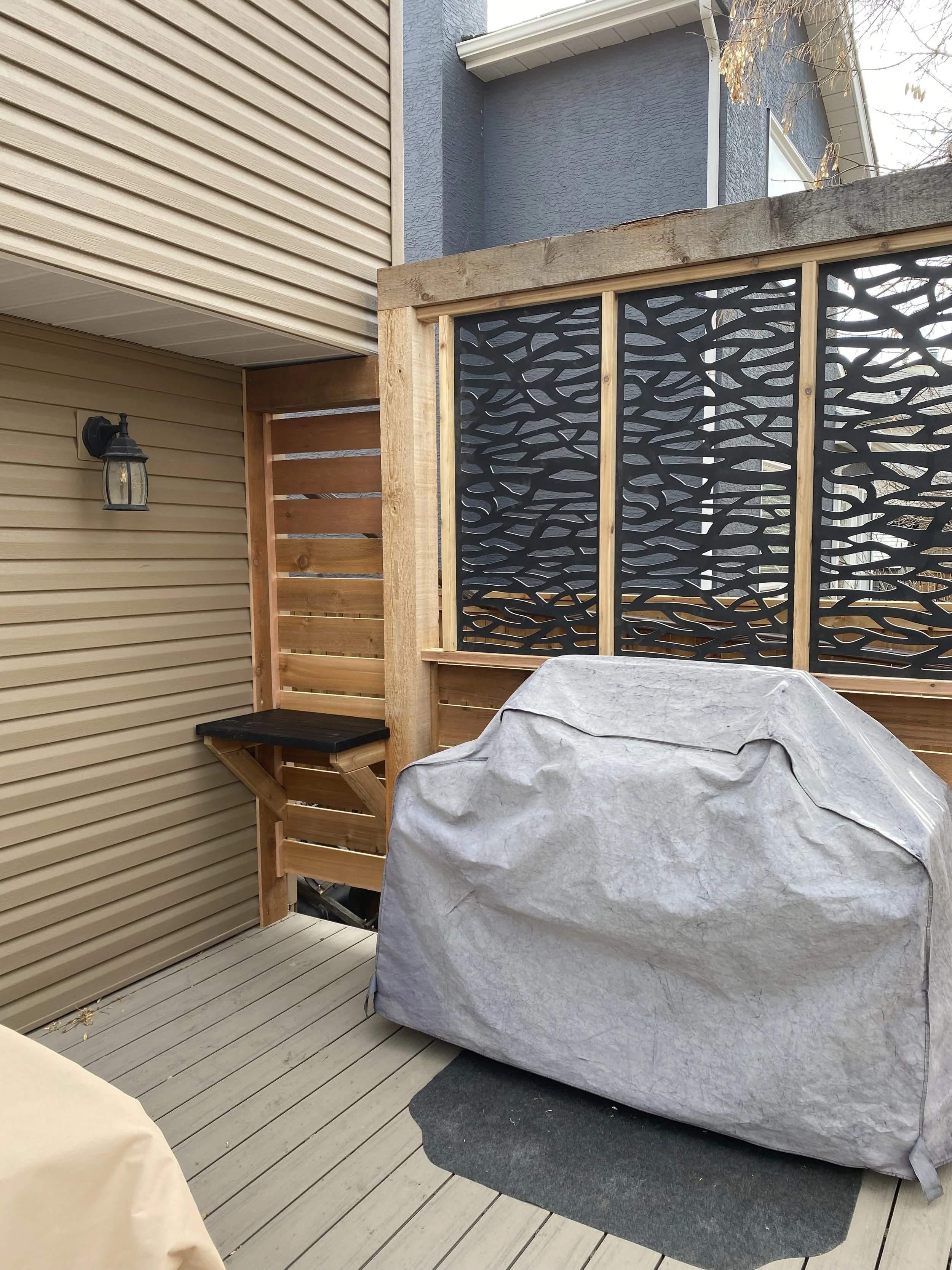 Built cedar and composite privacy screen and built-in counter tops for privacy, security and easy access to back door.