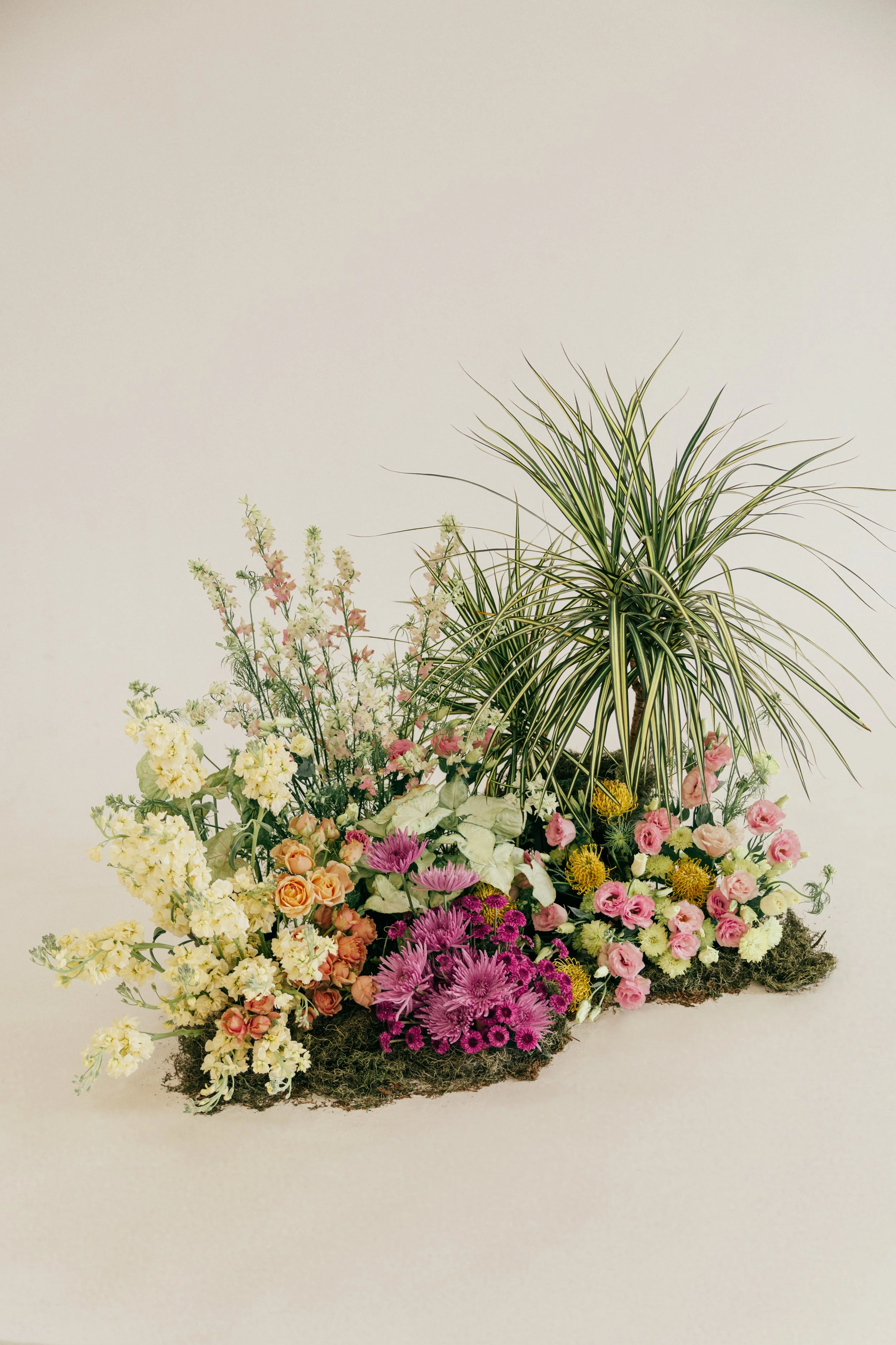 Color blocked flower arrangement, modern floral grouping with many colors.