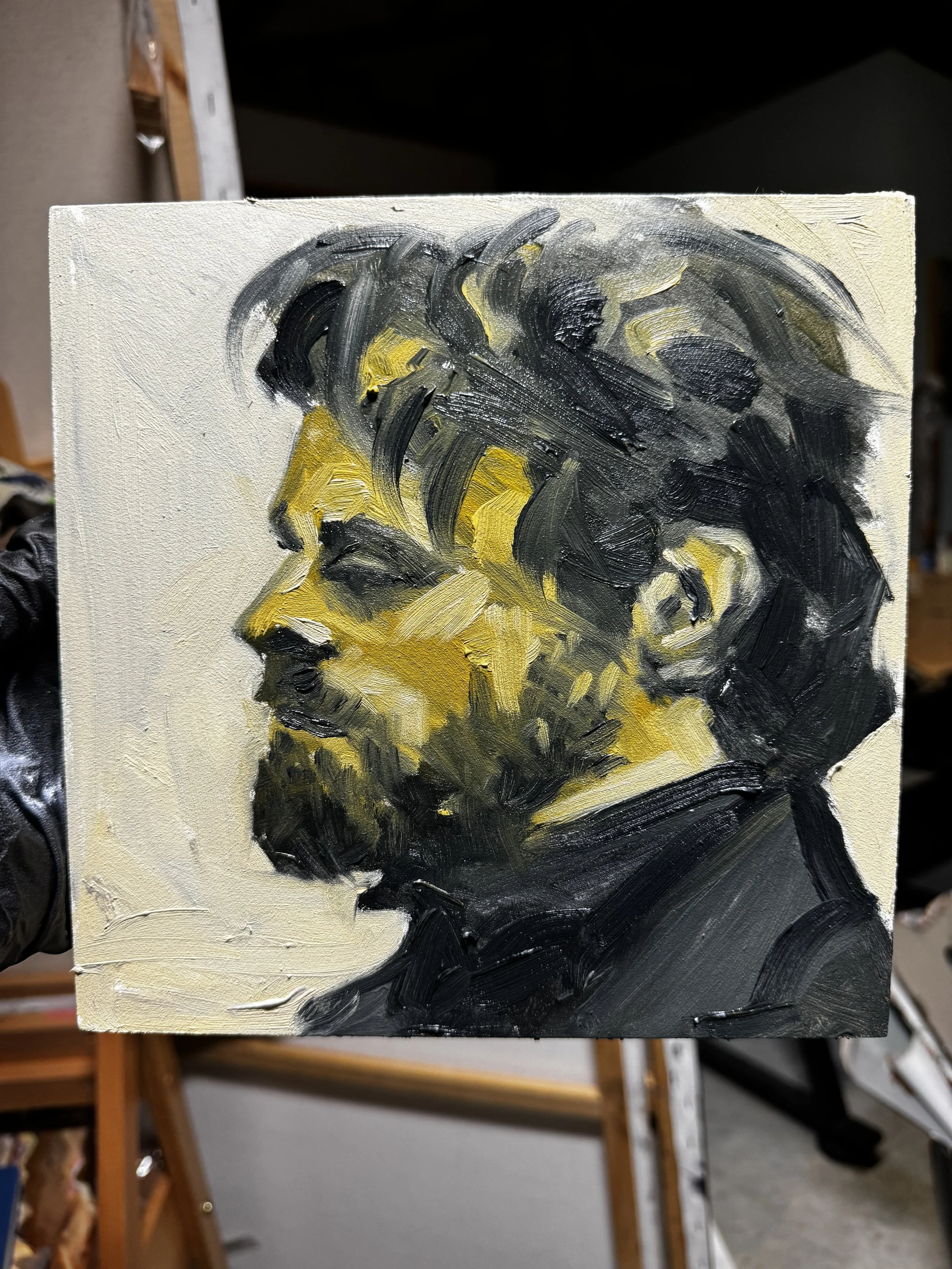 An oil painting of a man's profile in black and yellow tones, depicting a bearded man with textured brushstrokes.