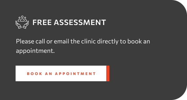 Dark gray block with white text and a small icon offering 'FREE ASSESSMENT' and 'Please call or email the clinic directly to book an appointment.' There is a white button with red text that says 'BOOK AN APPOINTMENT'.