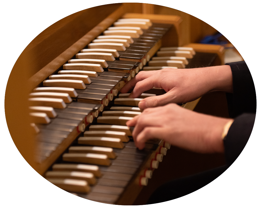 A person playing a wooden piano keyboard.