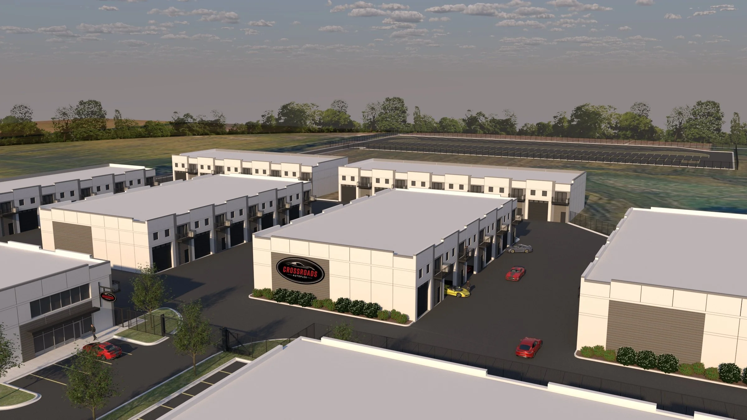 Aerial rendering of The Crossroads Autoplex showing multiple garage condo buildings, gated drive lanes, and on-site parking.