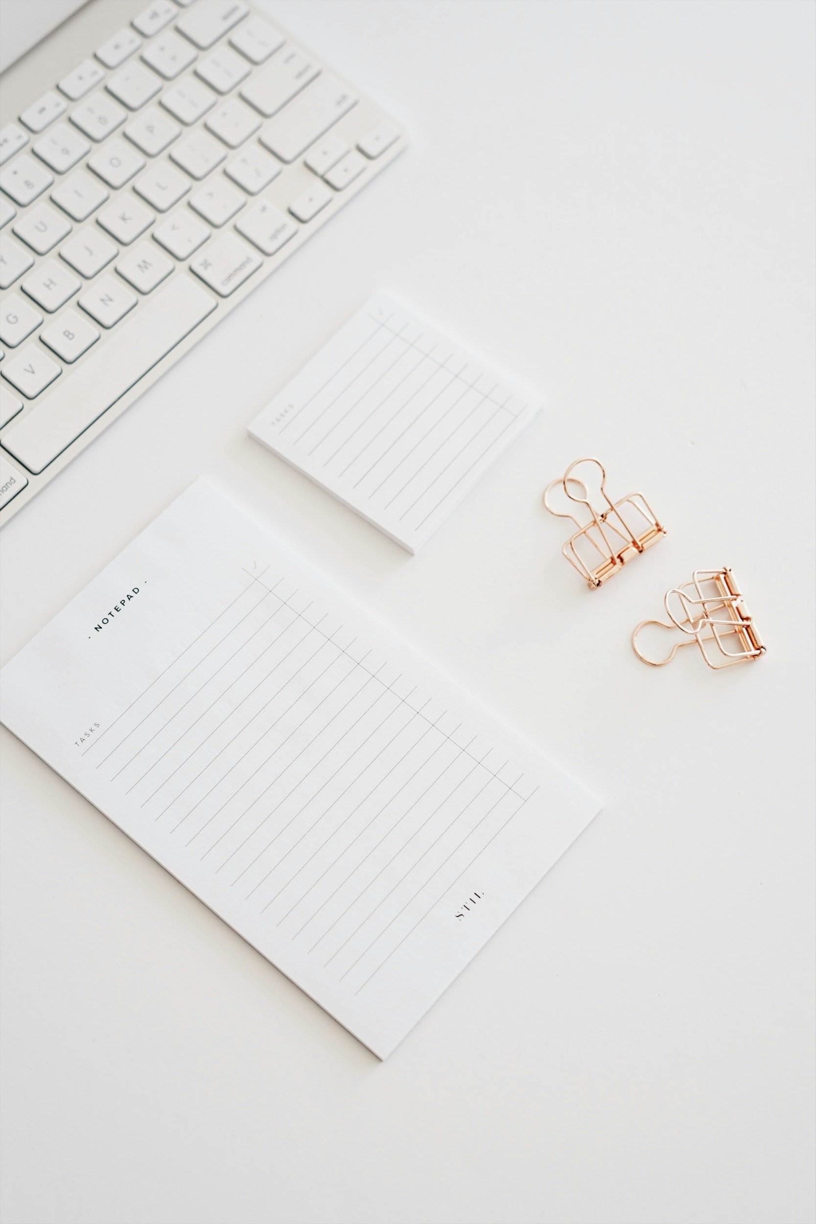 notepad and binder clips on a desk.