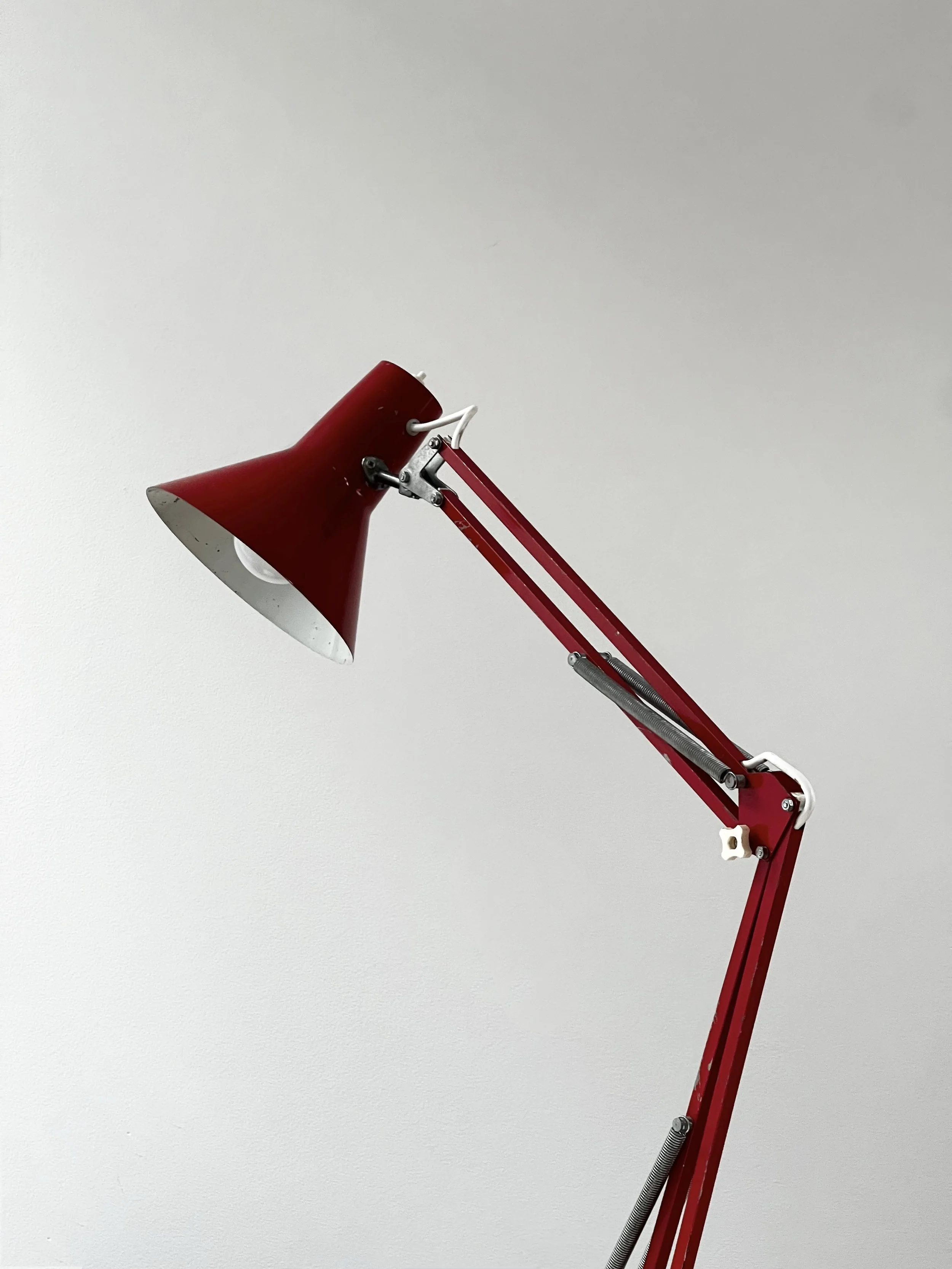 red anglepoise lamp —  unknown