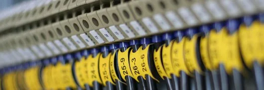 Close-up of electrical circuit breakers labeled with amperage ratings.