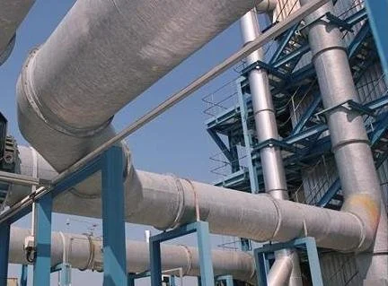 Industrial pipes and metal structures at a factory or plant.