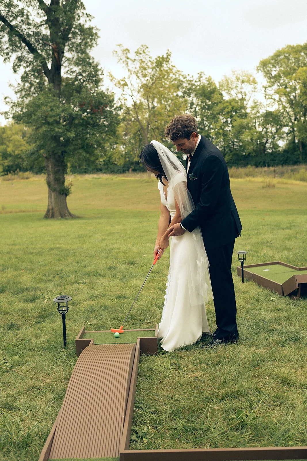 bride and groom mini golf at wedding reception
