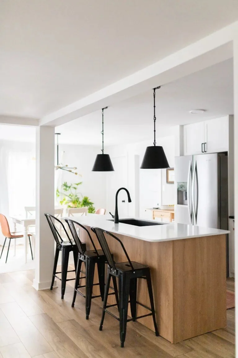 bright warm kitchen with white cabinets and warm wood finishes