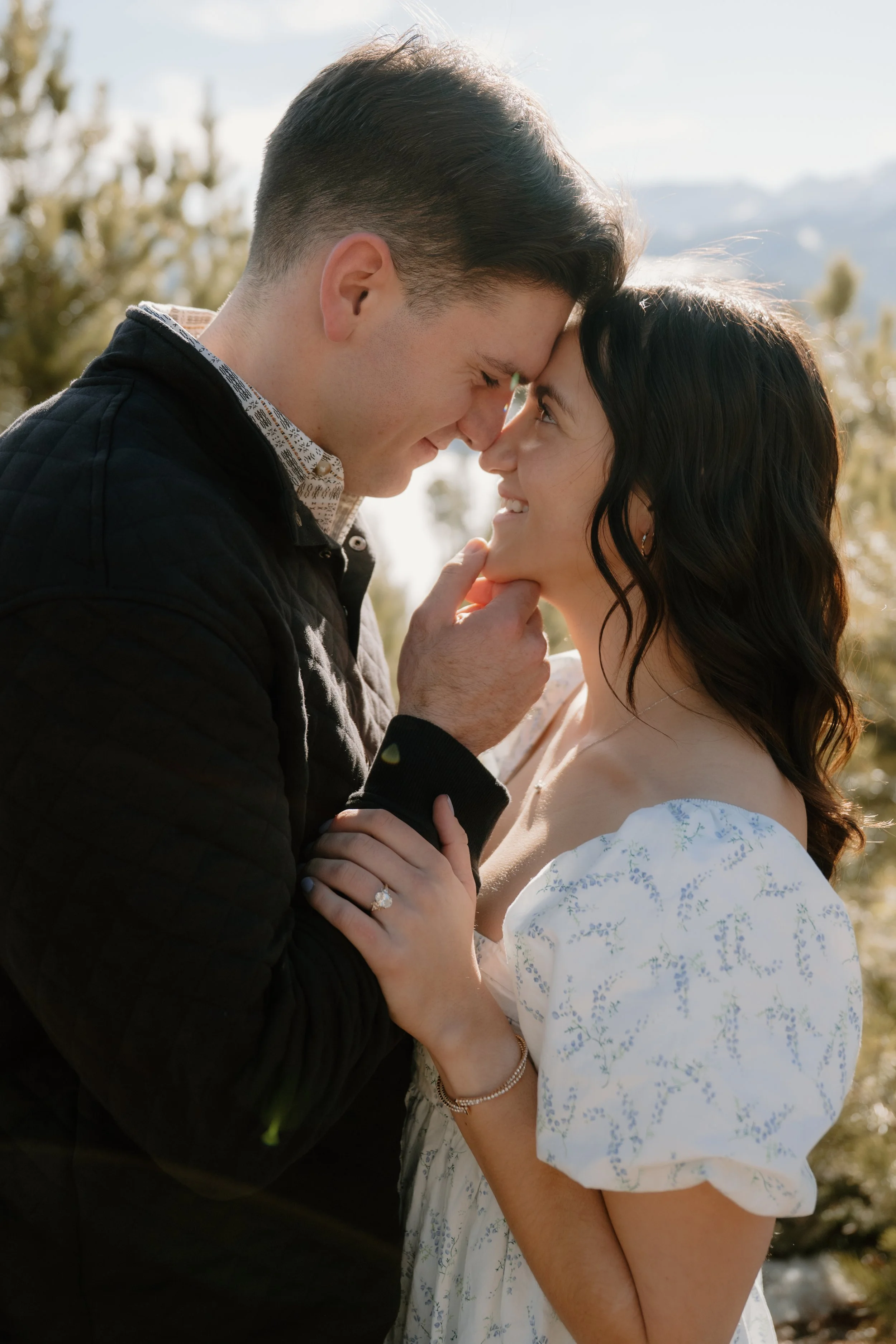 Engaged western couple embracing at Dillon Lake in Silverthorne Colorado