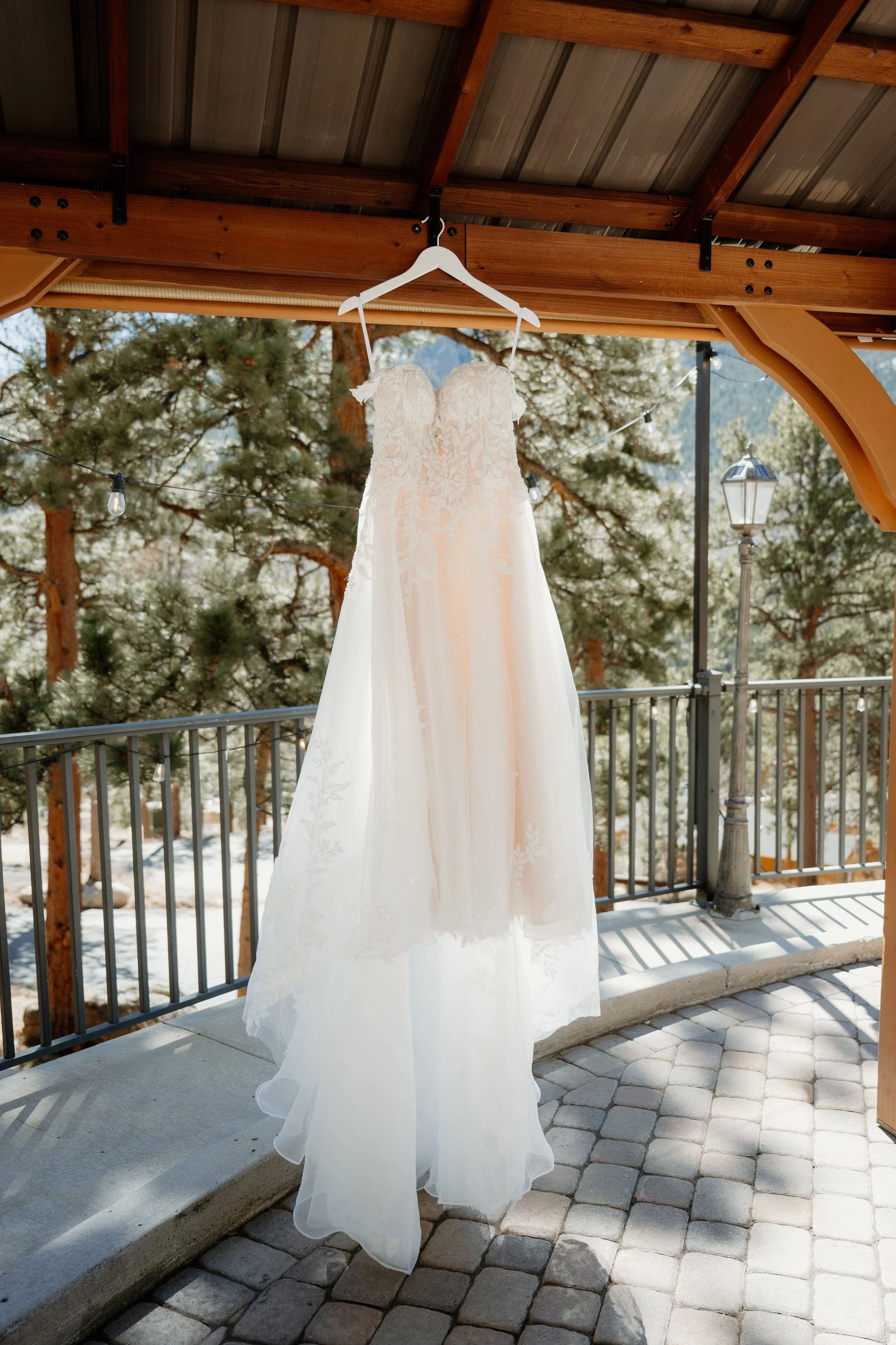 A floral and sparkly wedding dress hanging at Della Terra in Estes Park Colorado