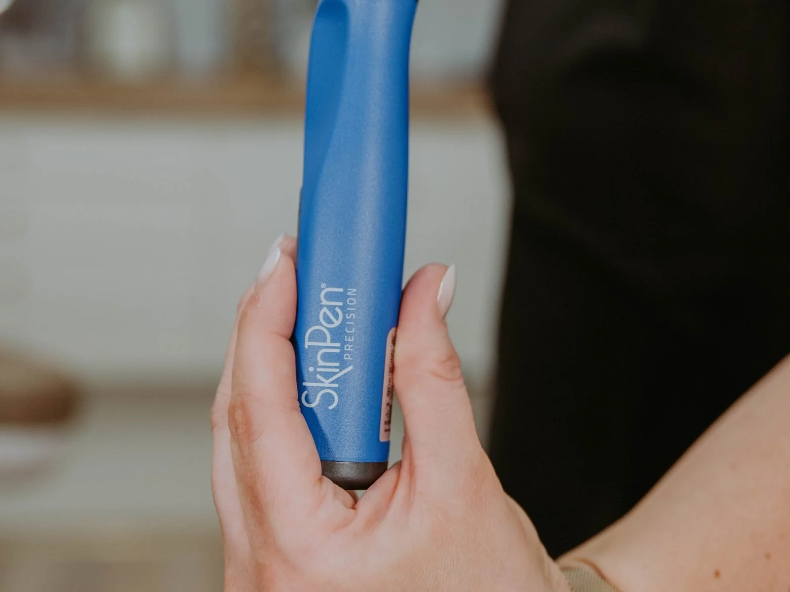 Microneedling pen used for collagen-boosting skin treatments at Atlas