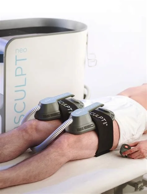 Patient receiving cryotherapy treatment on leg with two cryo devices attached and connected to a cooling machine.
