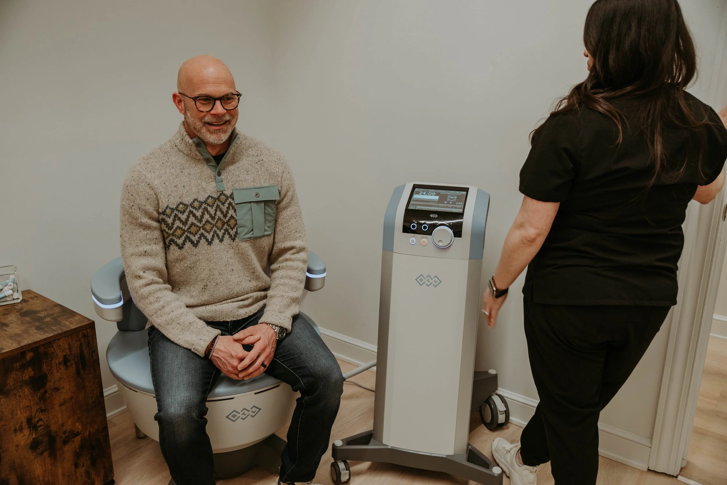 Patient seated in the Emsella chair at Atlas Health & Wellness in Mount Vernon, Ohio