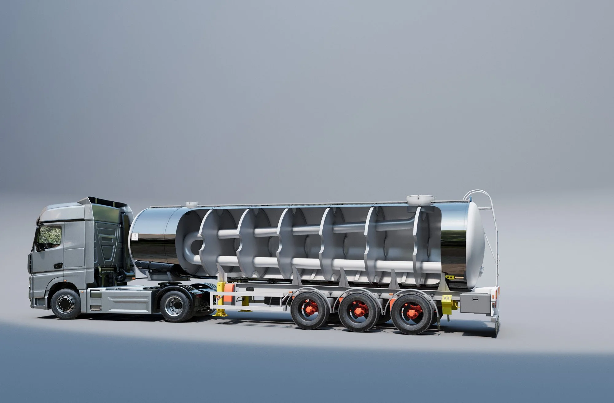 A large truck with a streamlined cab and six wheels, carrying a big, metallic, cylindrical industrial machine secured on its flatbed trailer.