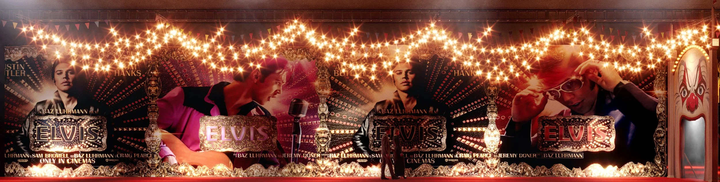 A colorful, vintage-style Elvis Presley-themed carnival or theater display with images of Elvis, a microphone, string lights, and decorative elements.