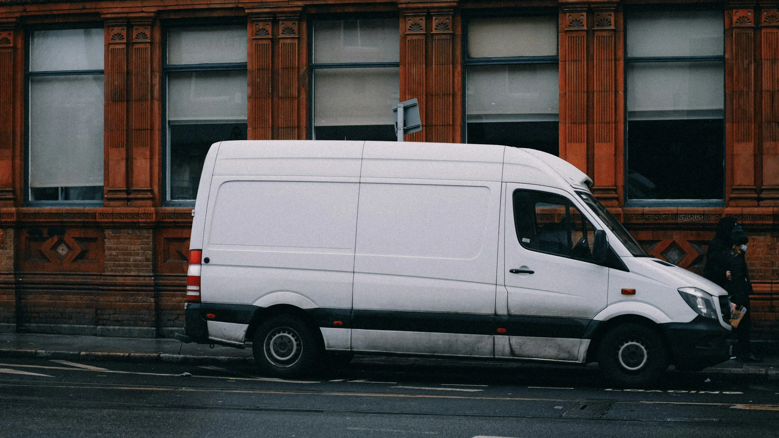 White delivery van parked on a city street