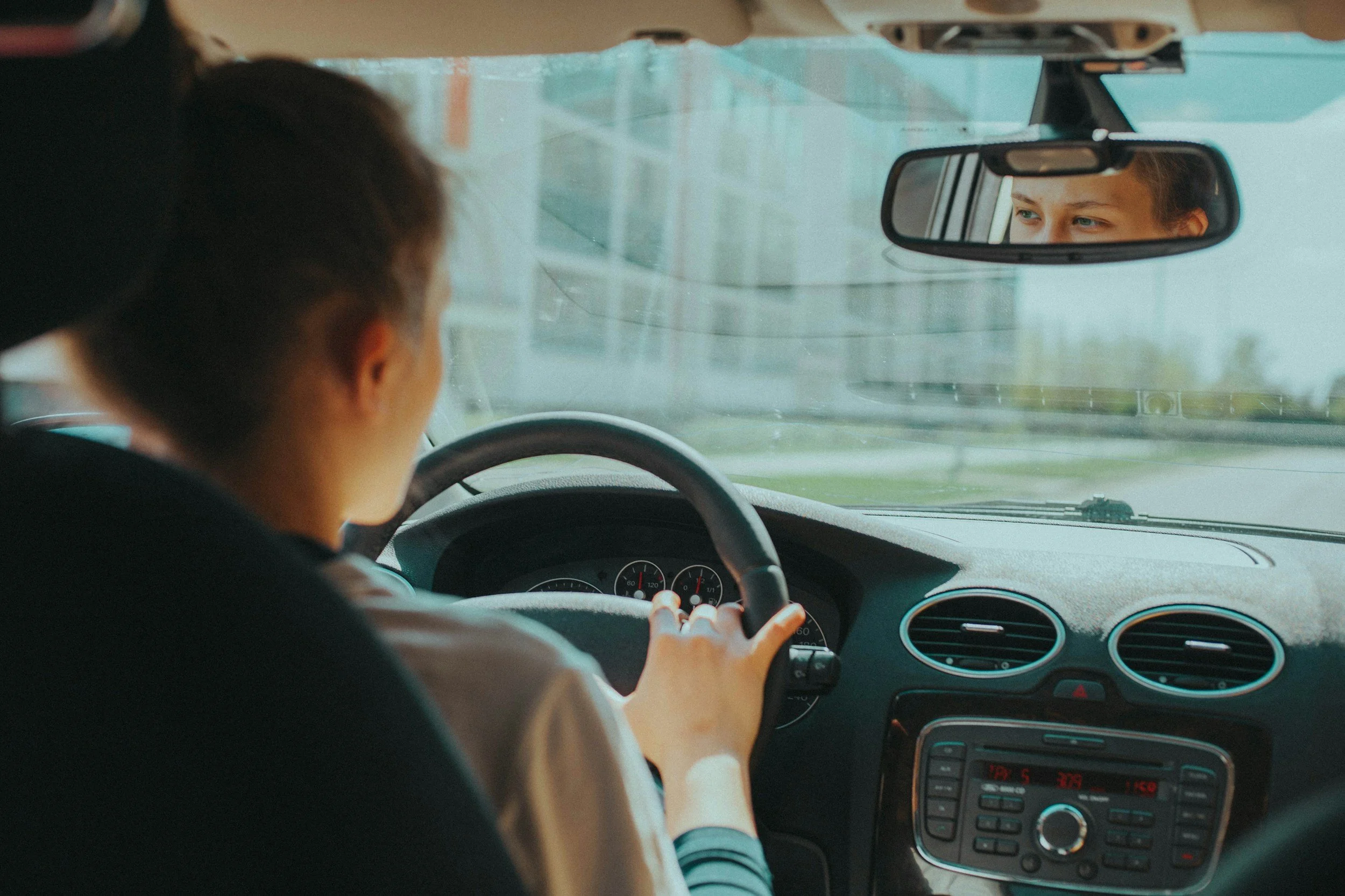 Young driver behind the wheel of a car