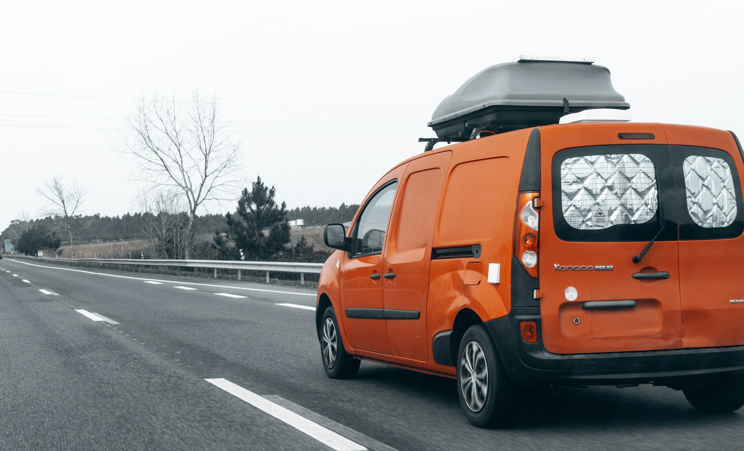 Work van driving on a highway, representing car accidents while working