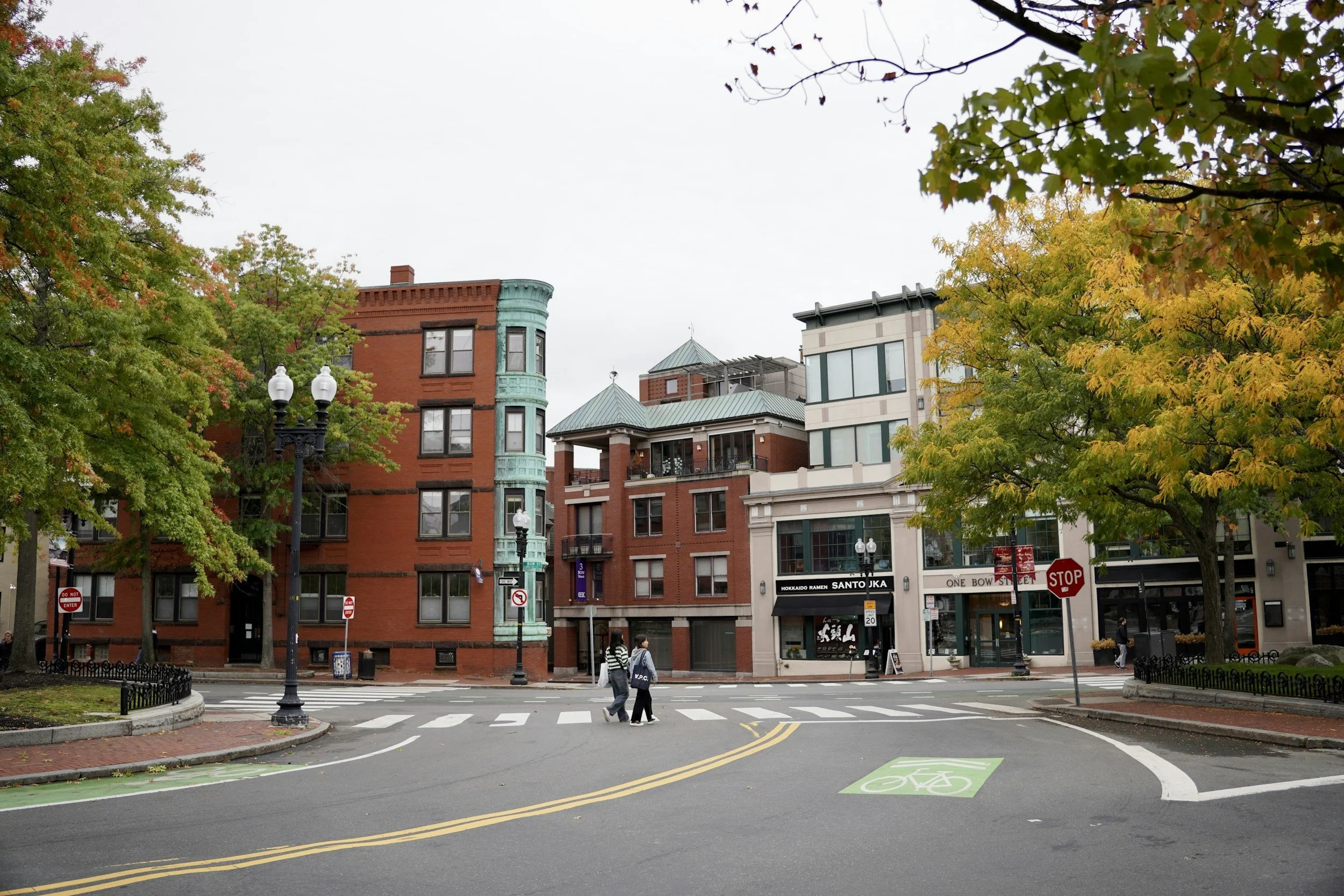 Intersection with a crosswalk and brick buildings on an autumn day