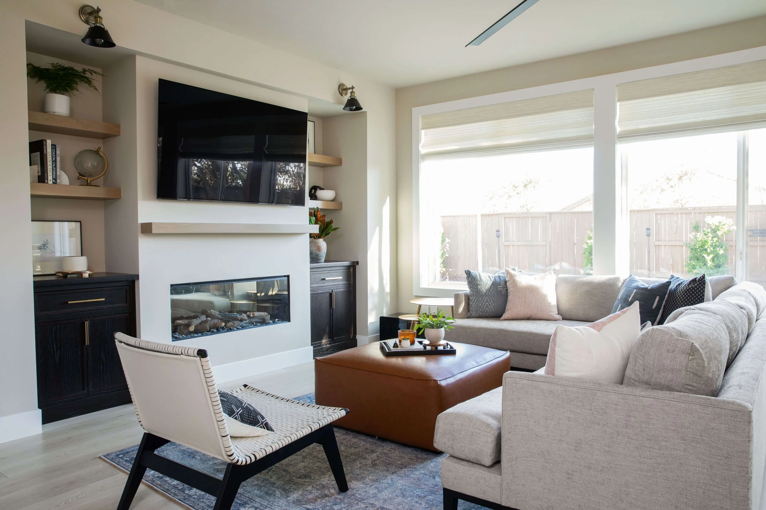 A comfortable living area with floating shelves on either side of the fireplace mantle