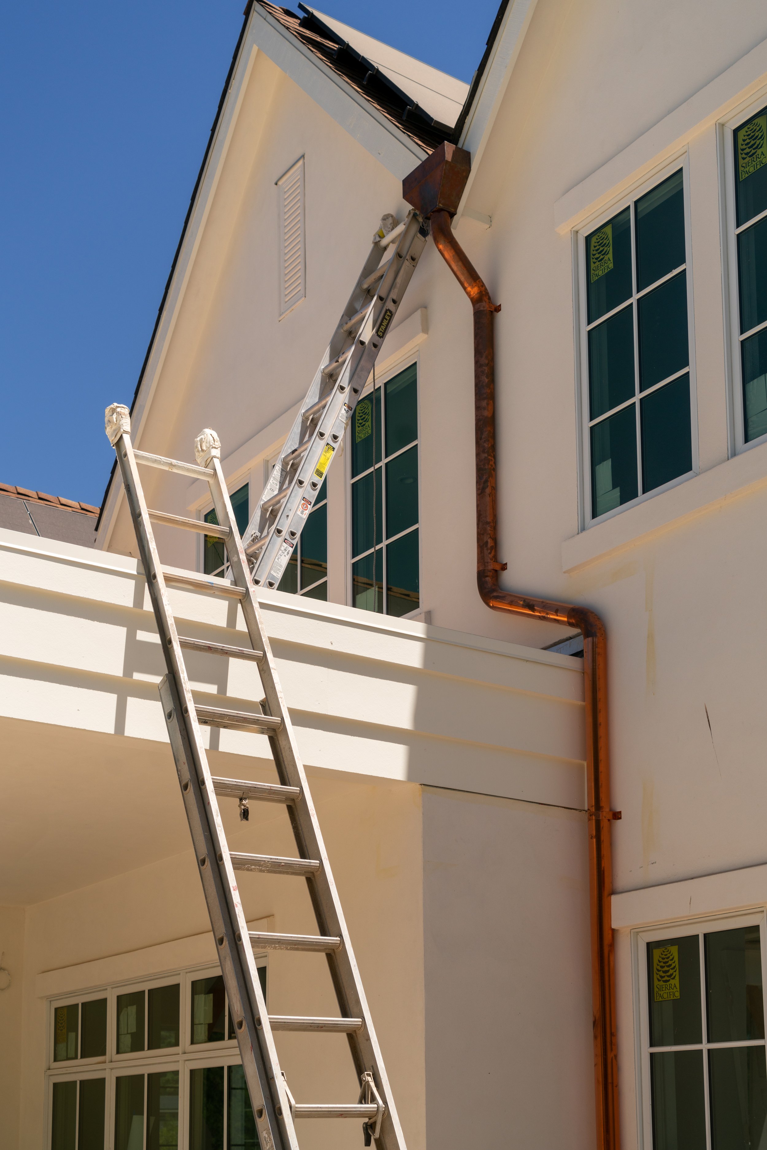 Exterior of a Sacramento custom home with stucco exterior and copper gutters