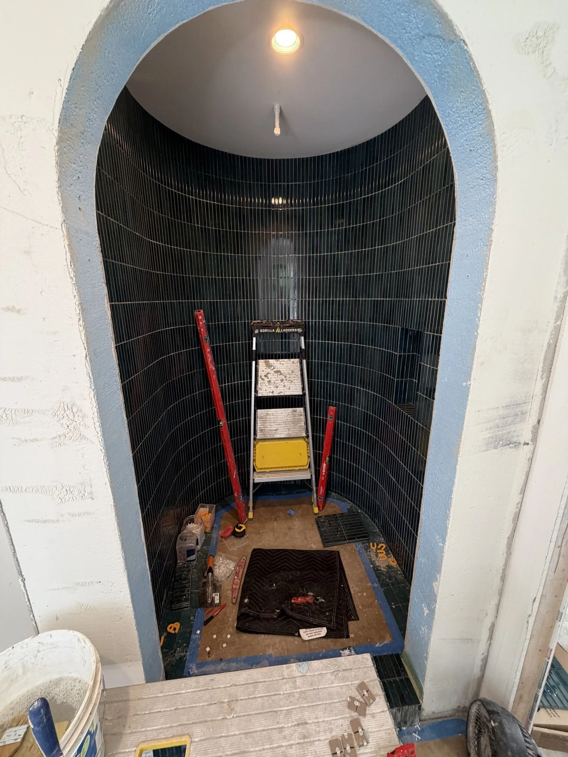 The interior of a walk-in shower with luxurious tile work