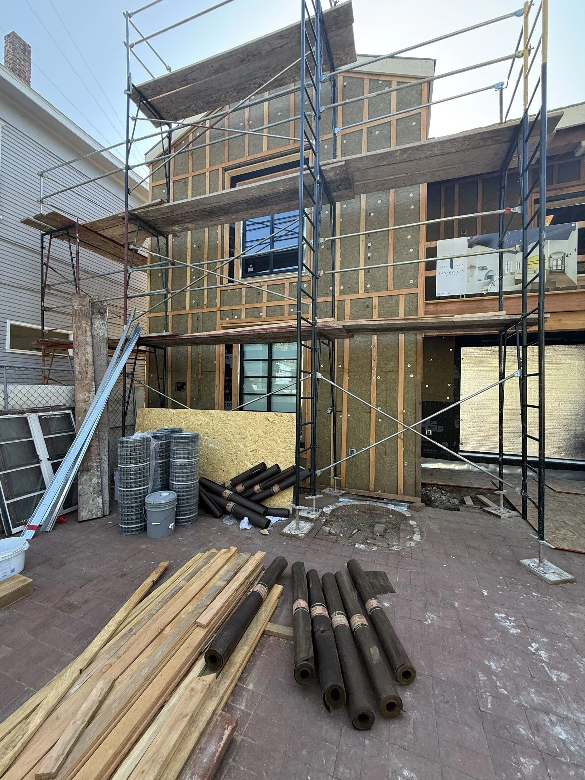 Scaffolding set up on the exterior of a Tankersley custom home