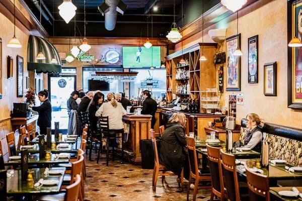 Patrons sit at the bar or at tables in Dominick's Italian Restaurant and Deli