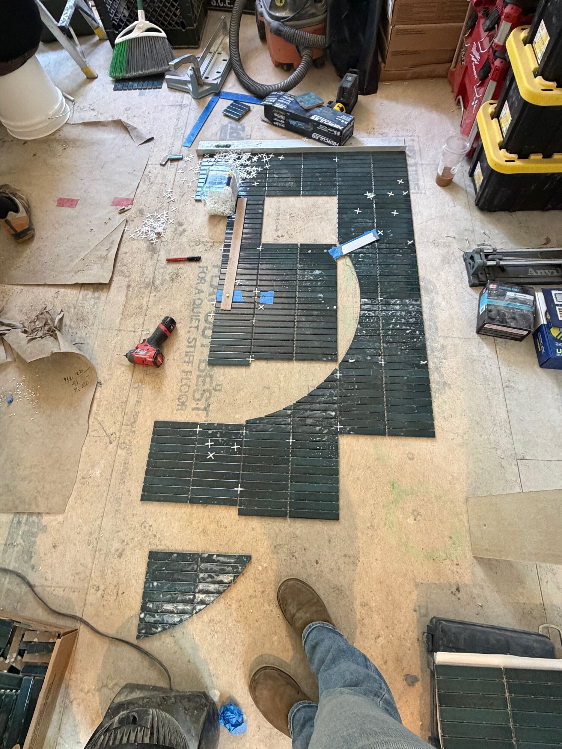 Tile being laid out and cut for a master bathroom shower backsplash