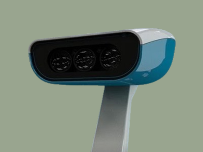 A close-up of a modern fitness tracker or smart device with a screen displaying three circular icons on a light green background.