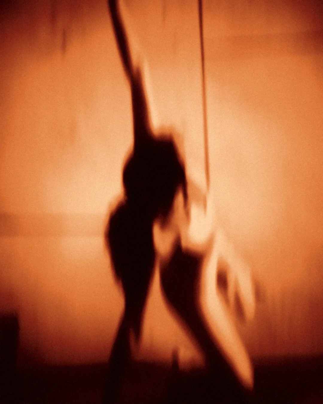 Power Flow: a silhouette mid-movement against a glowing wall