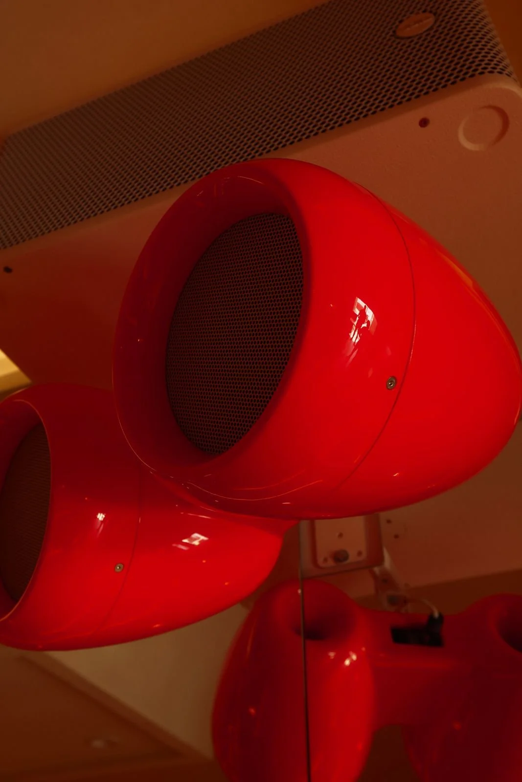 Glossy red VOID Acoustics speakers mounted in the Room