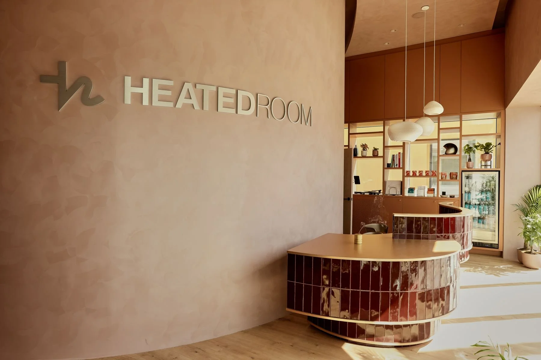 Santa Monica lobby with the Heated Room logo wall & tiled front desk